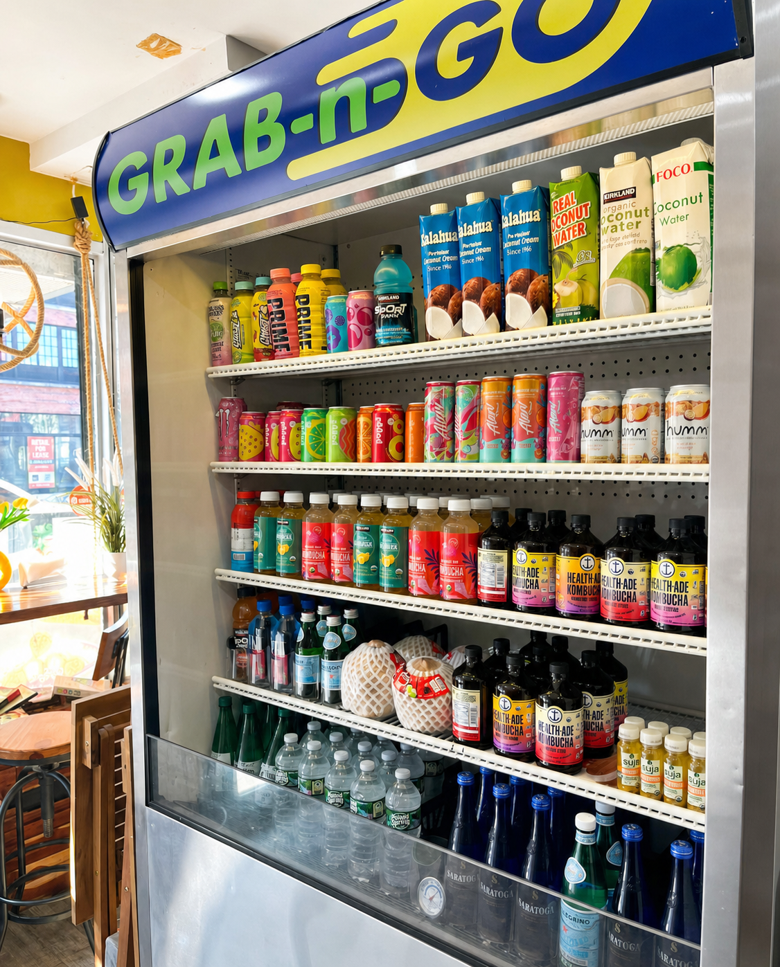 Colorful grab-and-go drinks and coconut water stocked in The Blend Factory refrigerator